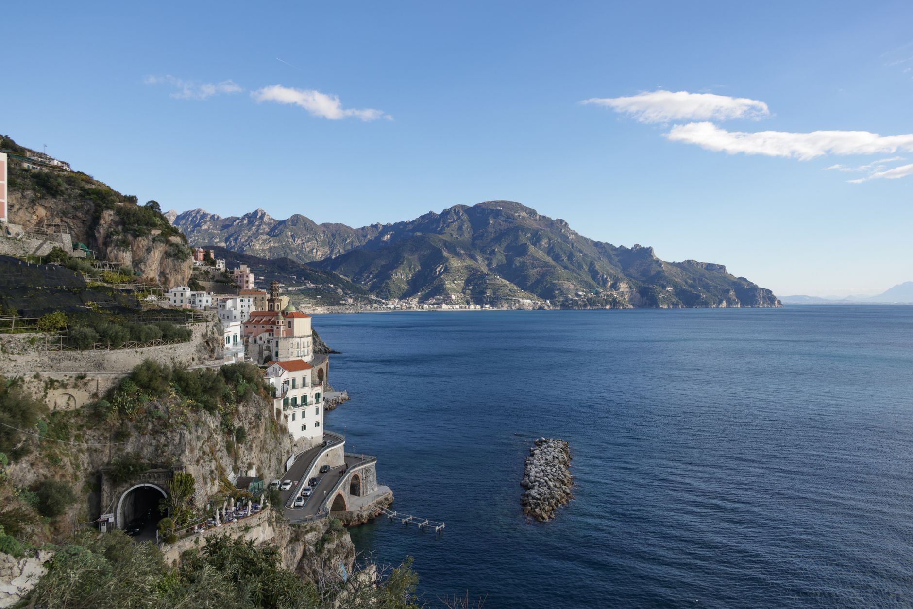 Sunlit Mediterranean seaside cliff and lemon groves
